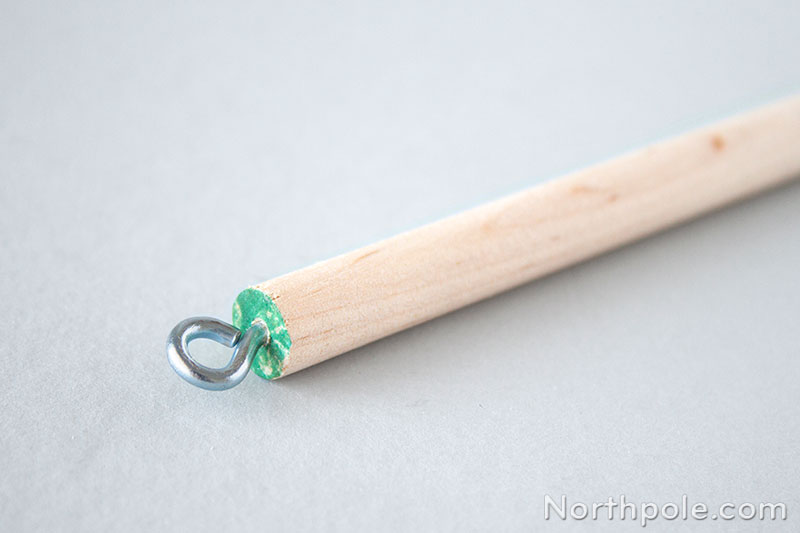 Use a screw eye as an inconspicious way to hang the backdrop.